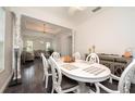 Open dining area showcases elegant decor, stylish table setting, and seamless flow to living room at 5231 Lemon Twist Ln, Windermere, FL 34786