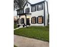 Well-maintained two-story home featuring a manicured lawn and inviting entrance at 5231 Lemon Twist Ln, Windermere, FL 34786