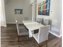 Stylish dining room with a modern table set and attractive artwork on the walls at 8121 Fan Palm Way, Kissimmee, FL 34747