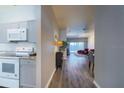 Bright hallway leading to an open kitchen and dining area with tile floors at 8121 Fan Palm Way, Kissimmee, FL 34747
