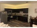 Well-appointed kitchen featuring stainless steel appliances, granite countertops, and wood cabinetry at 892 Grandin St, Davenport, FL 33837