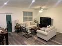 Spacious living room with hard surface floors, neutral paint, and abundant seating at 892 Grandin St, Davenport, FL 33837