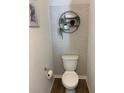 Cozy powder room with decorative wallpaper, floating shelves with plant decor, and modern fixtures at 892 Grandin St, Davenport, FL 33837