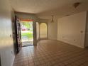 Bright living room with tile floors, neutral walls, and a view of the front yard through the large window at 925 Derbyshire Dr, Kissimmee, FL 34758