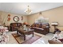 Inviting living room features comfortable brown leather sofas, a patterned rug, and a decorative coffee table at 1526 Ferendina Dr, Deltona, FL 32725