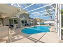 Inviting screened-in pool area with ample seating, perfect for outdoor relaxation at 108 Honeywood Ct, Kissimmee, FL 34743