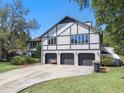 Multi-story home featuring a three-car garage and set in a well-maintained landscape at 11951 Elbert St, Clermont, FL 34711