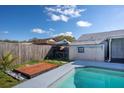 Backyard features a unique wood deck, a small canopy and an outdoor storage shed by the swimming pool at 1375 Springfield St, Kissimmee, FL 34744