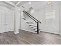 Inviting entryway with wood-look floors, staircase, and an open floorplan at 1379 Kiawah St, Celebration, FL 34747