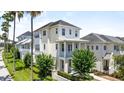 Charming two-story stucco homes with double balconies, landscaped yards, and sidewalks at 1379 Kiawah St, Celebration, FL 34747