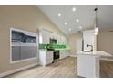 Beautiful modern kitchen with white cabinets, stainless steel appliances, and a green tile backsplash at 14639 Musket Fire Ln, Orlando, FL 32837