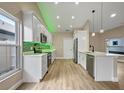 Bright open kitchen with white cabinets, stainless steel appliances, and a breakfast bar with pendant lighting at 14639 Musket Fire Ln, Orlando, FL 32837