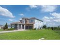 Beautiful two-story home with a well-manicured lawn, a two-car garage, and a tile roof at 15600 Vetta Dr, Bella Collina, FL 34756