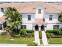 Detailed aerial shot of a townhome showcasing landscaping and tile roofing at 1565 Plunker Dr, Davenport, FL 33896