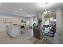Bright open-concept living area featuring modern furnishings and sliding glass doors at 1565 Plunker Dr, Davenport, FL 33896