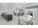 Open-concept space with dining area, large windows, and sliding glass doors to outdoor patio at 1578 Slice Way, Davenport, FL 33896