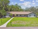 Beautiful single story home with large front lawn, mailbox, and inviting walkway to the front door at 16 Pine Forest Dr, Haines City, FL 33844