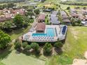 Aerial view showing the pool and spa area, complete with lounge chairs, for community residents at 16049 Volterra Pt, Bella Collina, FL 34756