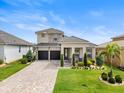 Beautiful two-story home featuring a well-maintained lawn and a convenient two-car garage at 16049 Volterra Pt, Bella Collina, FL 34756