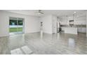 Spacious living room with open floor plan and stainless steel kitchen appliances at 2211 Simmons St, Leesburg, FL 34748