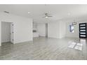 Open-concept living area featuring stylish gray flooring and abundant natural light at 2211 Simmons St, Leesburg, FL 34748
