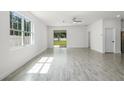 Bright living room with sliding glass doors leading to the backyard at 2211 Simmons St, Leesburg, FL 34748