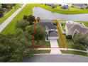 Aerial view of property featuring lush landscaping and a serene pond at 2503 Calla Lily Cv, Kissimmee, FL 34758