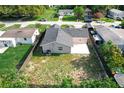 Aerial view of a fenced-in backyard with a concrete patio and grass at 2629 Williston Dr, Lakeland, FL 33801