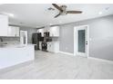 Open-concept living room showcasing stainless steel appliances and a door leading to the backyard at 2629 Williston Dr, Lakeland, FL 33801