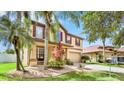 Charming home featuring mature trees, beautiful landscaping, and well-maintained lawn at 2722 Corybrooke Ln, Kissimmee, FL 34744