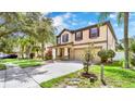 Inviting home with a manicured lawn, mature trees, and a spacious two-car garage at 2722 Corybrooke Ln, Kissimmee, FL 34744