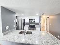 Updated kitchen with stainless steel appliances, granite countertops, and tile backsplash at 2735 N Poinciana Blvd # 95, Kissimmee, FL 34746