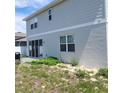 View of the house with a patio and some green space in the backyard at 312 Lake Smart Cir, Winter Haven, FL 33881