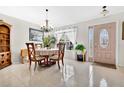 Cozy dining room featuring a round table with seating for four and tile flooring adjacent to the front entrance at 3261 Sawgrass Creek Cir, St Cloud, FL 34772