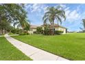 Lovely one-story home showcasing a vibrant green lawn and mature palm trees enhancing curb appeal at 3617 Northwoods Dr, Kissimmee, FL 34746