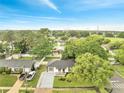 Aerial view of a single-story home with mature trees, a well-kept lawn, and a paved driveway at 3804 Anthony Ln, Orlando, FL 32822
