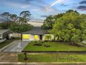 Charming single-story home with lush landscaping, modern driveway, and inviting curb appeal at 3804 Anthony Ln, Orlando, FL 32822