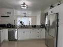 Modern kitchen with stainless steel appliances, granite countertops, and ample cabinet space at 416 Sea Willow Dr, Kissimmee, FL 34743