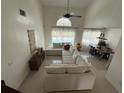 Bright living room with high ceilings, tile flooring, and plenty of natural light overlooking pool at 416 Sea Willow Dr, Kissimmee, FL 34743