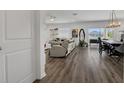 Open-concept living area featuring wood floors, comfortable seating, and dining area with sliding doors at 5225 Tuscany Ln, Davenport, FL 33897