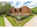 Corner townhome with well-kept hedges, a fenced yard and beautiful blue skies with fluffy white clouds at 5251 Brook Ct # 242, Orlando, FL 32811