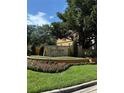 Serenata condo residences sign with manicured landscaping and colorful flowers at 6169 Metrowest Blvd # 208, Orlando, FL 32835
