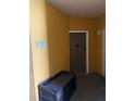 Condo hallway with unit 208 entrance and storage bench at 6169 Metrowest Blvd # 208, Orlando, FL 32835