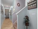 Hallway features beige-tiled flooring, neutral-colored walls, and decorative accents at 6834 Habitat Dr, Harmony, FL 34773