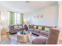 Inviting living room with large window offering ample natural light and comfortable seating at 8491 Oasis Key Cv, Kissimmee, FL 34747
