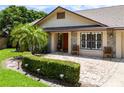 Inviting front entrance with a brick walkway, manicured hedges, and stone accents on the home's facade at 1016 Ohanlon Ct, Oviedo, FL 32765
