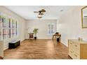 Spacious living room with wood-look floors, plantation shutters, and plenty of natural light at 1016 Ohanlon Ct, Oviedo, FL 32765