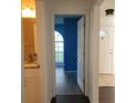 View of hallway and bedroom featuring newer floors and fresh paint at 1203 Atlantic Ct, Kissimmee, FL 34759
