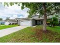 Beautiful single-Gathering home featuring a well-manicured lawn and a spacious two-car garage at 1659 Sage Creek Ct, Orlando, FL 32824