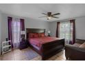 Spacious main bedroom with large windows and a comfortable bed at 166 Paradise Island Dr, Haines City, FL 33844